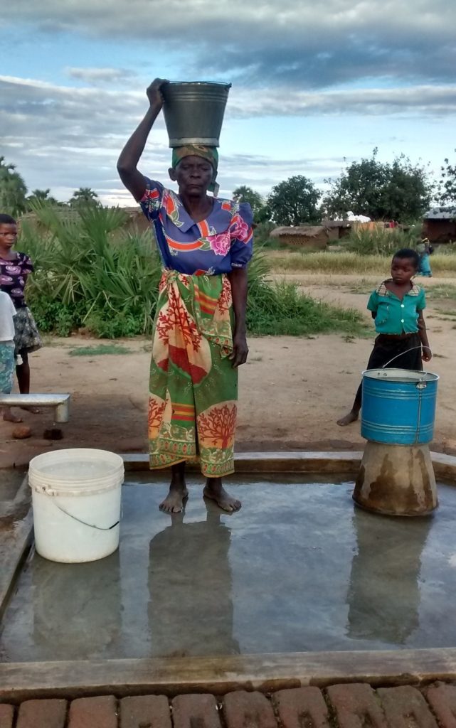 woman at borehole chapota village nkhotakota